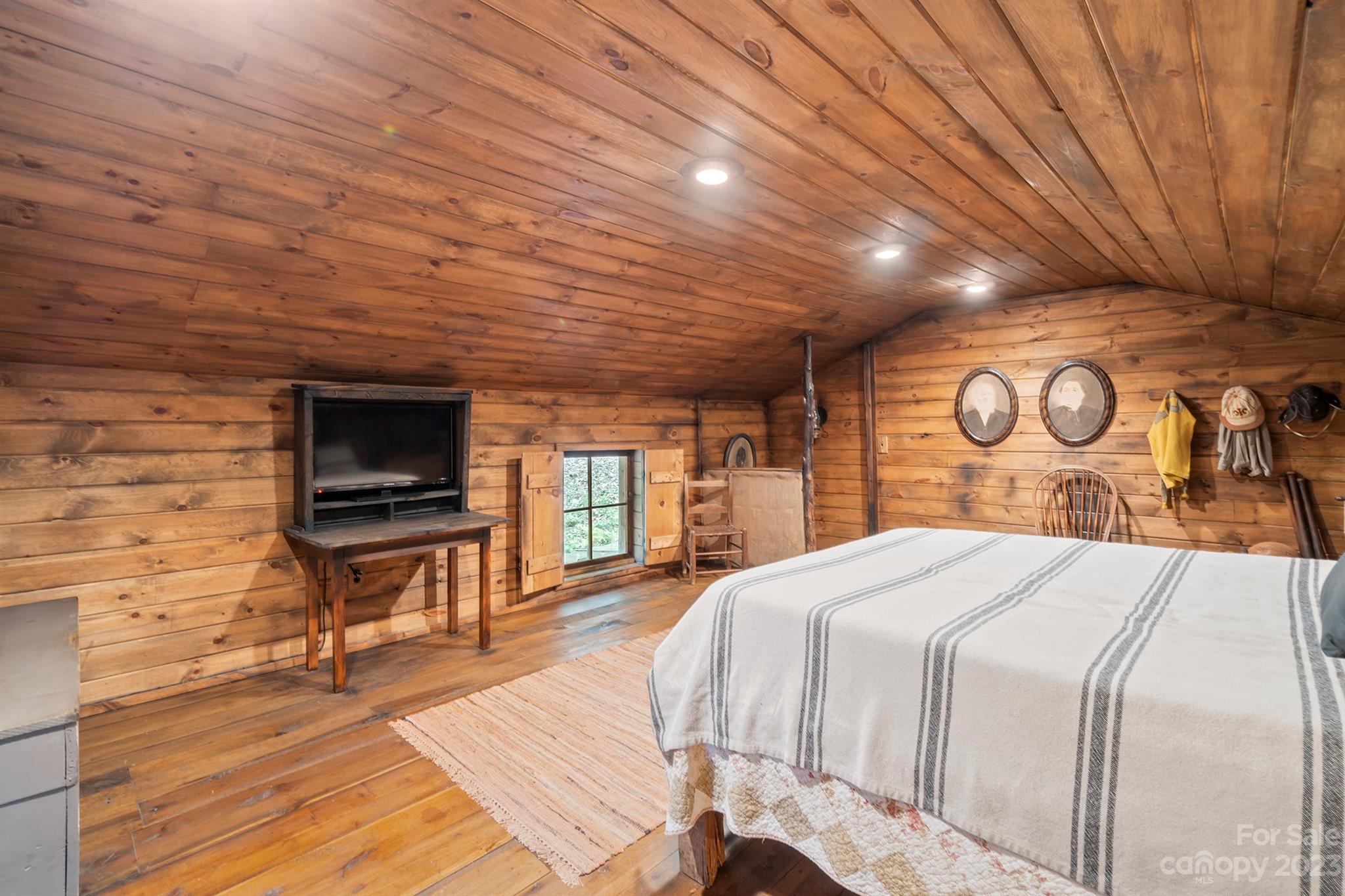 5646 Highway 18 Morganton, NC 28655 - Photo 30 of 37 a spacious bedroom with a bed and a flat screen tv