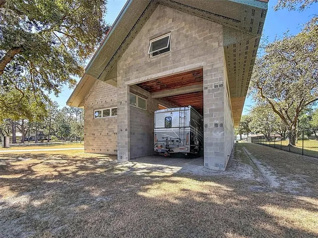 a view of a bedroom with wooden floor and windows