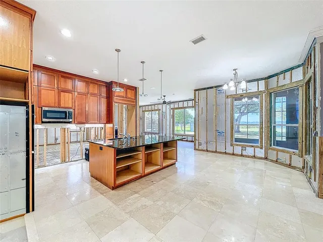 a view of a porch with wooden floor and furniture