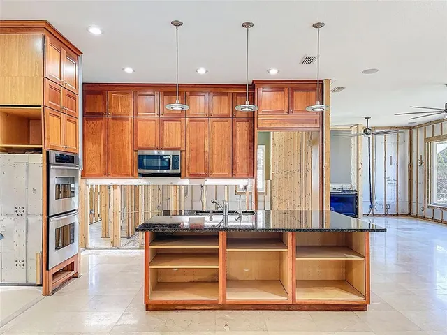 a view of a house with a big yard and large windows