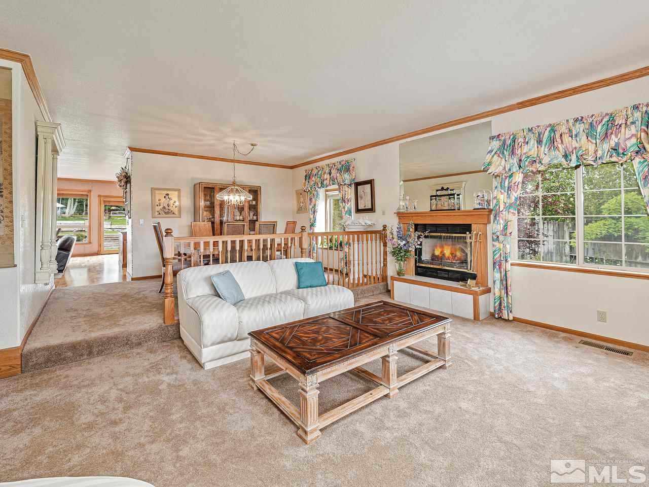35 Calla Lily Court Reno, NV 89511 - Photo 14 of 39 a living room with furniture a flat screen tv and a fireplace