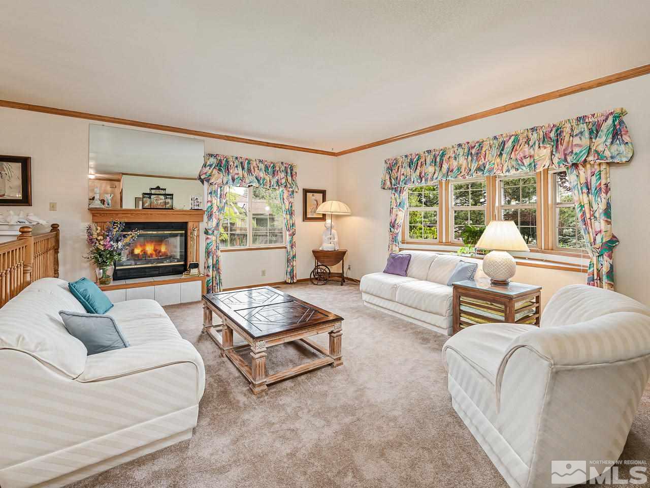 35 Calla Lily Court Reno, NV 89511 - Photo 15 of 39 a living room with furniture a flat screen tv and a large window