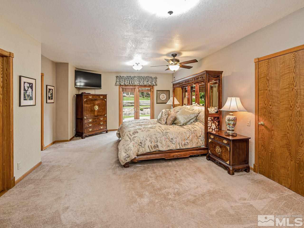 35 Calla Lily Court Reno, NV 89511 - Photo 16 of 39 a bedroom with a bed dresser and a window