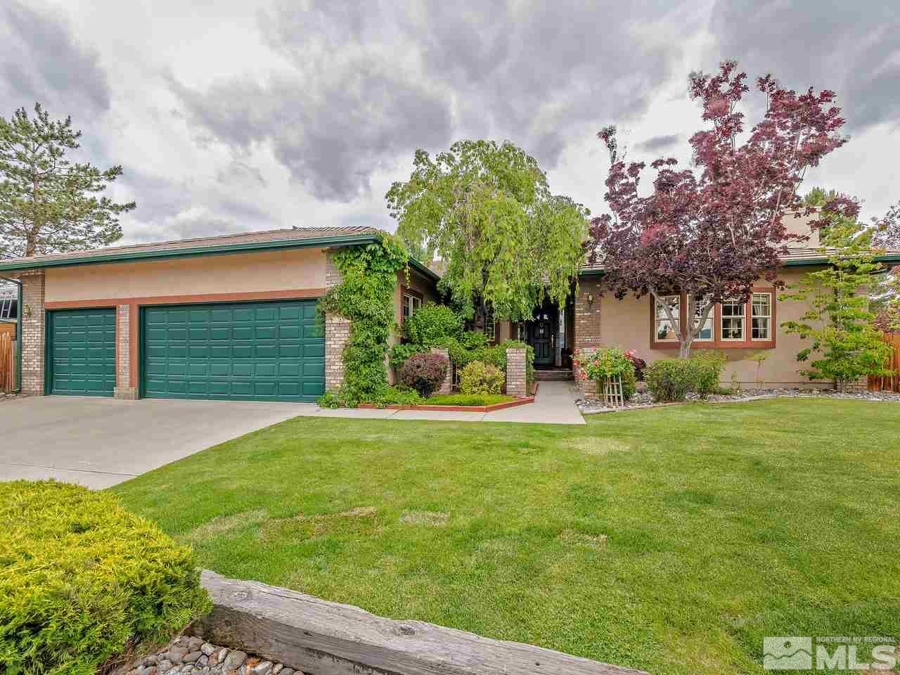 35 Calla Lily Court Reno, NV 89511 - Photo 2 of 39 a front view of a house with a yard and garage