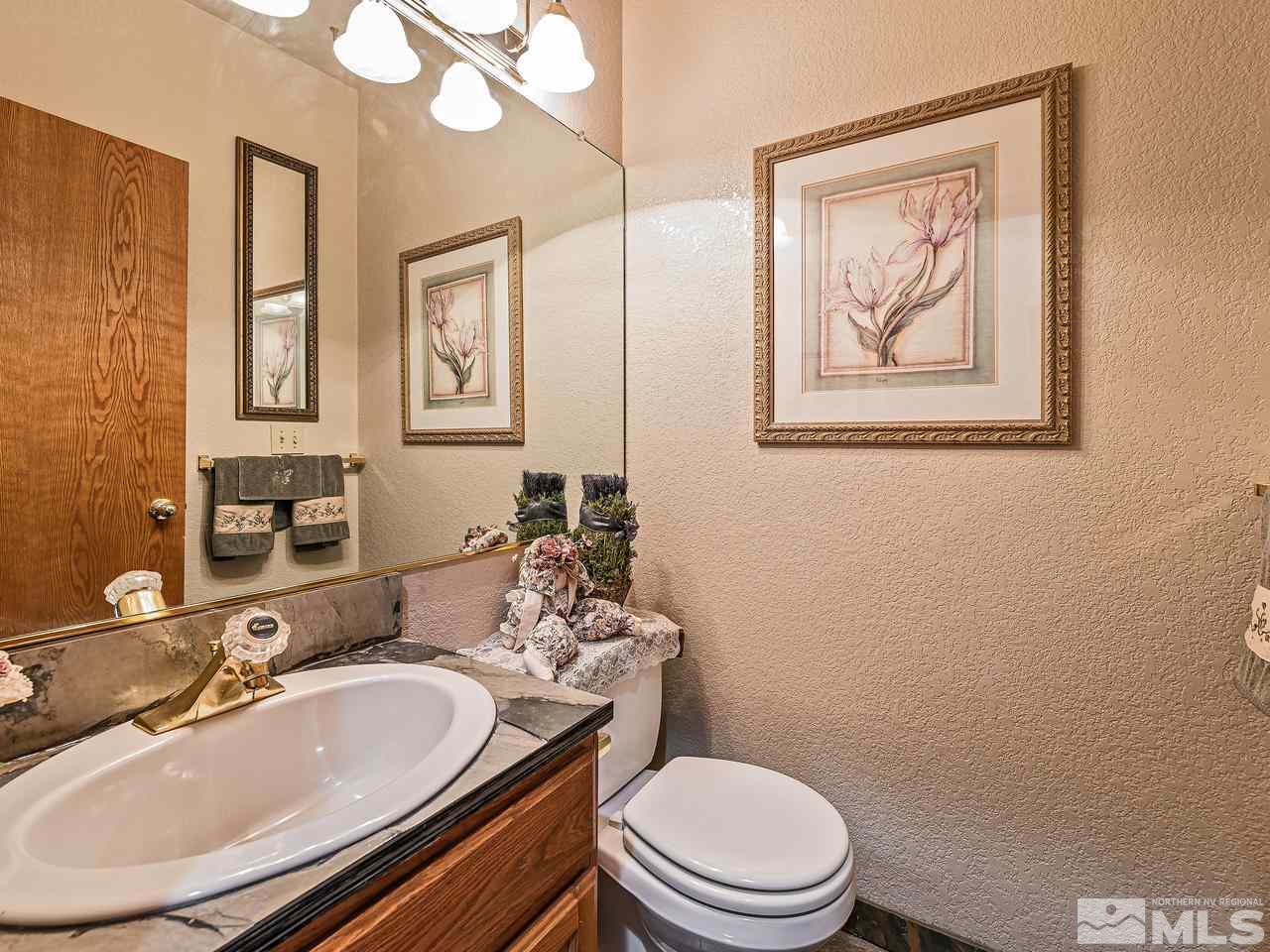 35 Calla Lily Court Reno, NV 89511 - Photo 23 of 39 a bathroom with a toilet a sink and mirror