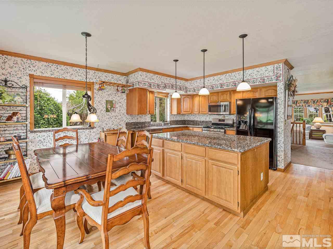 35 Calla Lily Court Reno, NV 89511 - Photo 5 of 39 a kitchen with stainless steel appliances granite countertop a stove a sink and a wooden floors