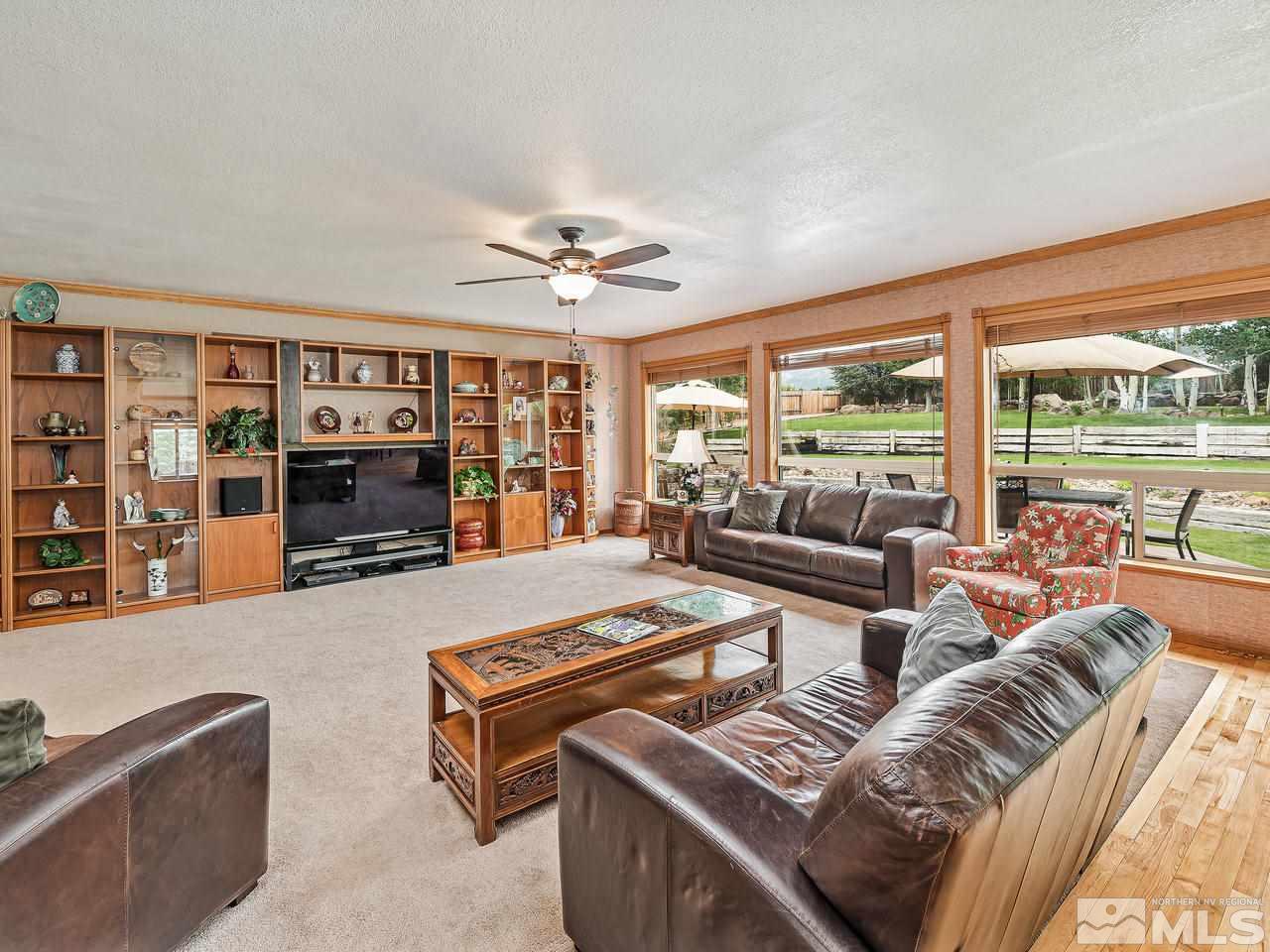 35 Calla Lily Court Reno, NV 89511 - Photo 8 of 39 a living room with furniture a rug and a large window