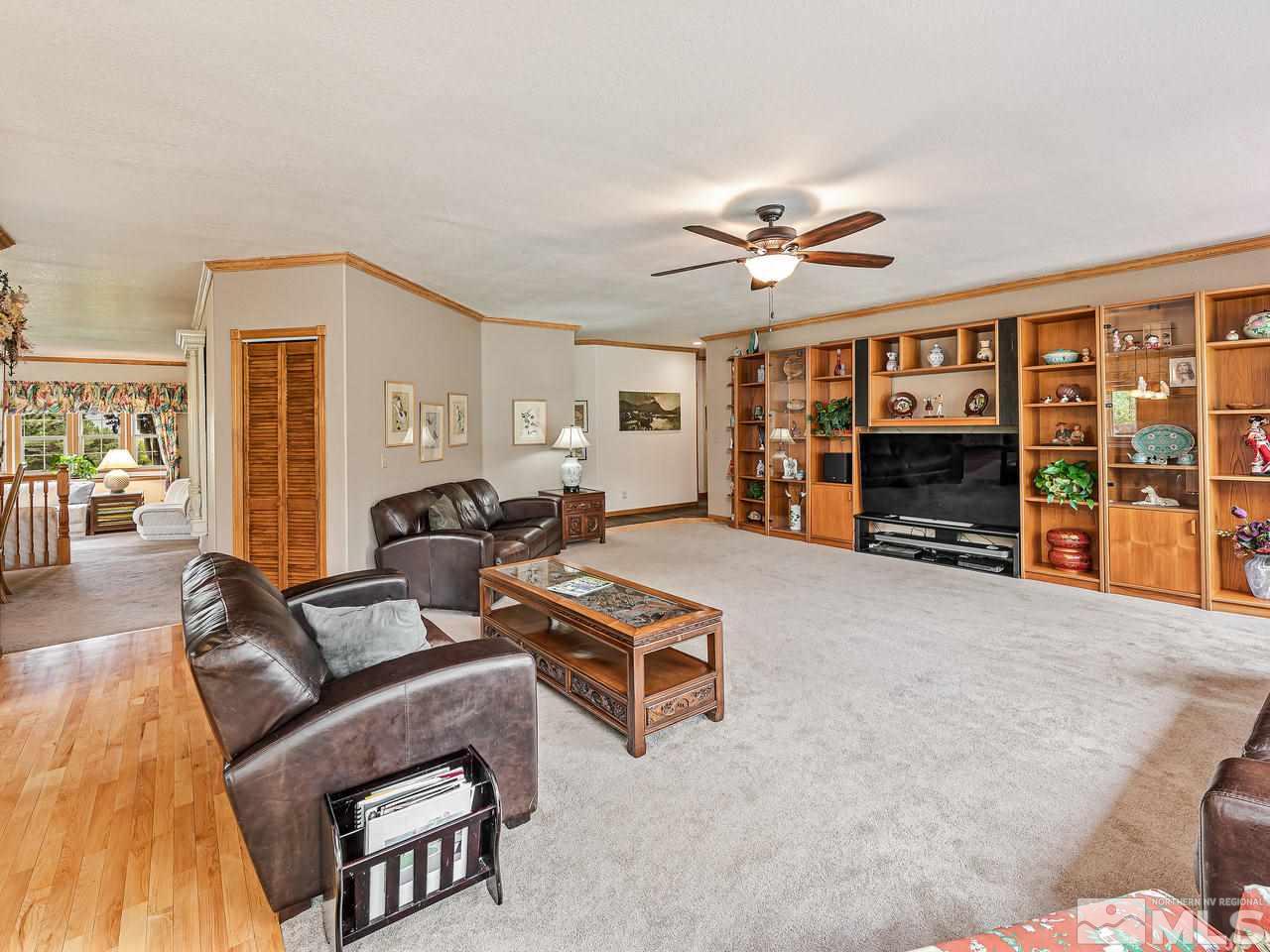 35 Calla Lily Court Reno, NV 89511 - Photo 10 of 39 a living room with furniture a fireplace and a flat screen tv