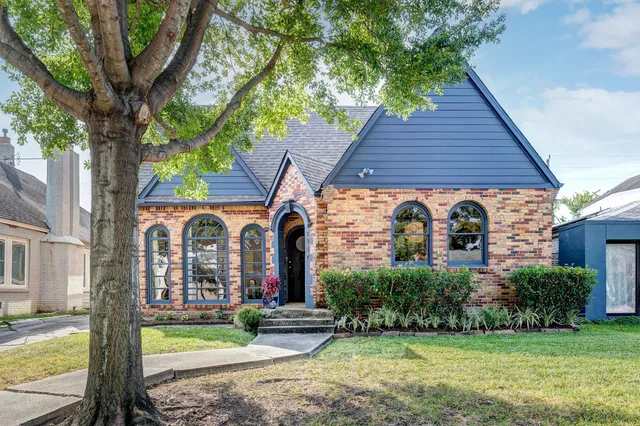 a front view of house with yard and green space