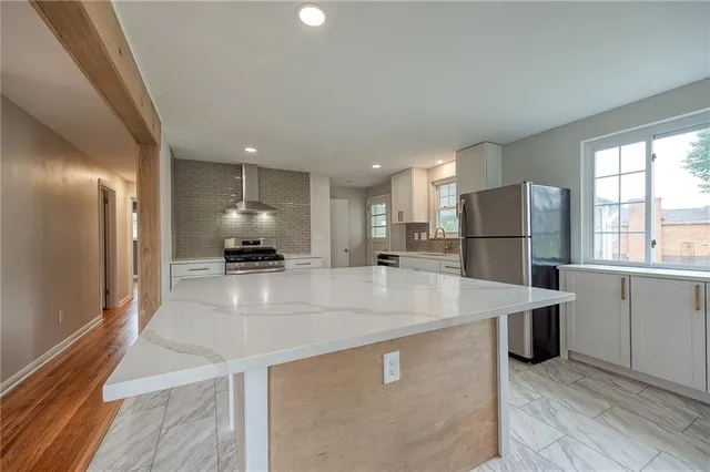 a kitchen with stainless steel appliances granite countertop a refrigerator sink and cabinets