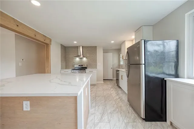 a kitchen with refrigerator and a sink