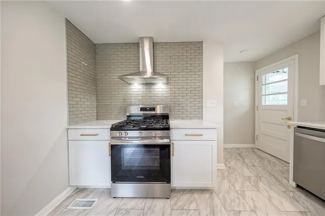 a kitchen with a stove and a refrigerator