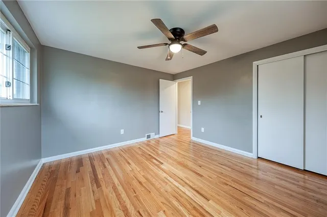 a view of an empty room and wooden floor