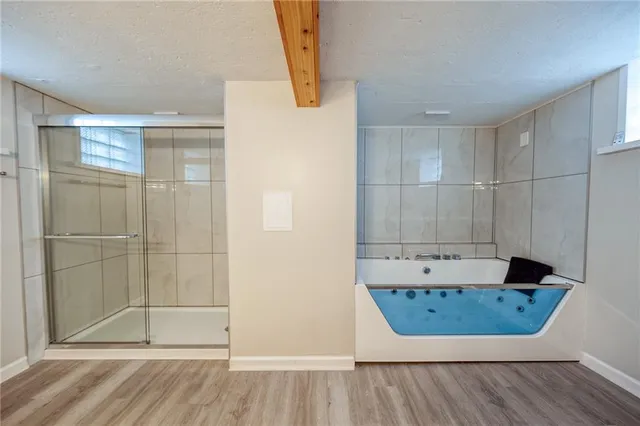 a view of a bathroom with a tub and shower