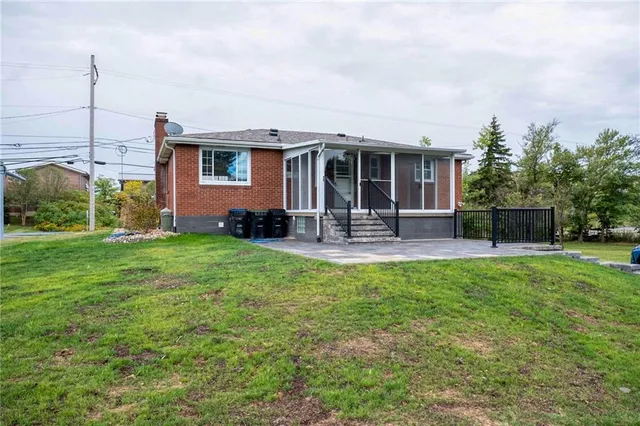 a view of a house with backyard porch and sitting area