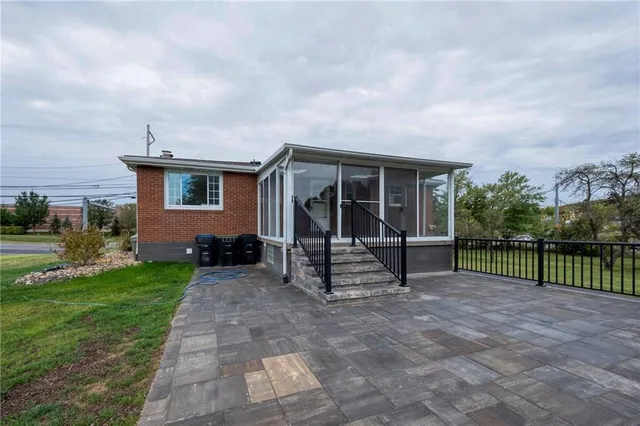 a view of a house with backyard and a garden