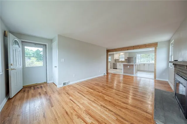 wooden floor in an empty room with a window