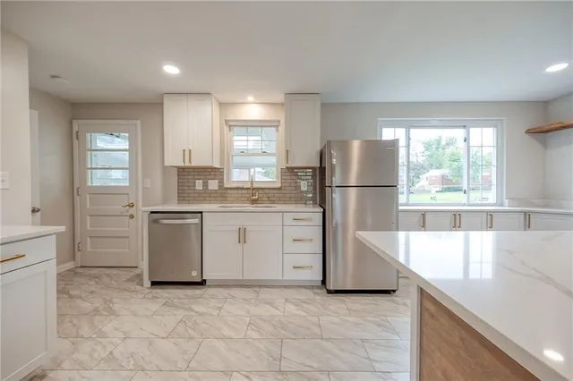 a kitchen with a stove a refrigerator and a sink