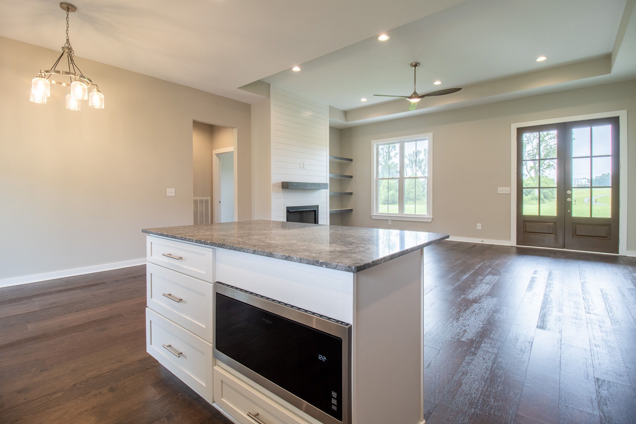 264 Dink Rut Road Portland, TN 37148 - Photo 22 of 56 a large kitchen with granite countertop a stove a sink and a wooden floor
