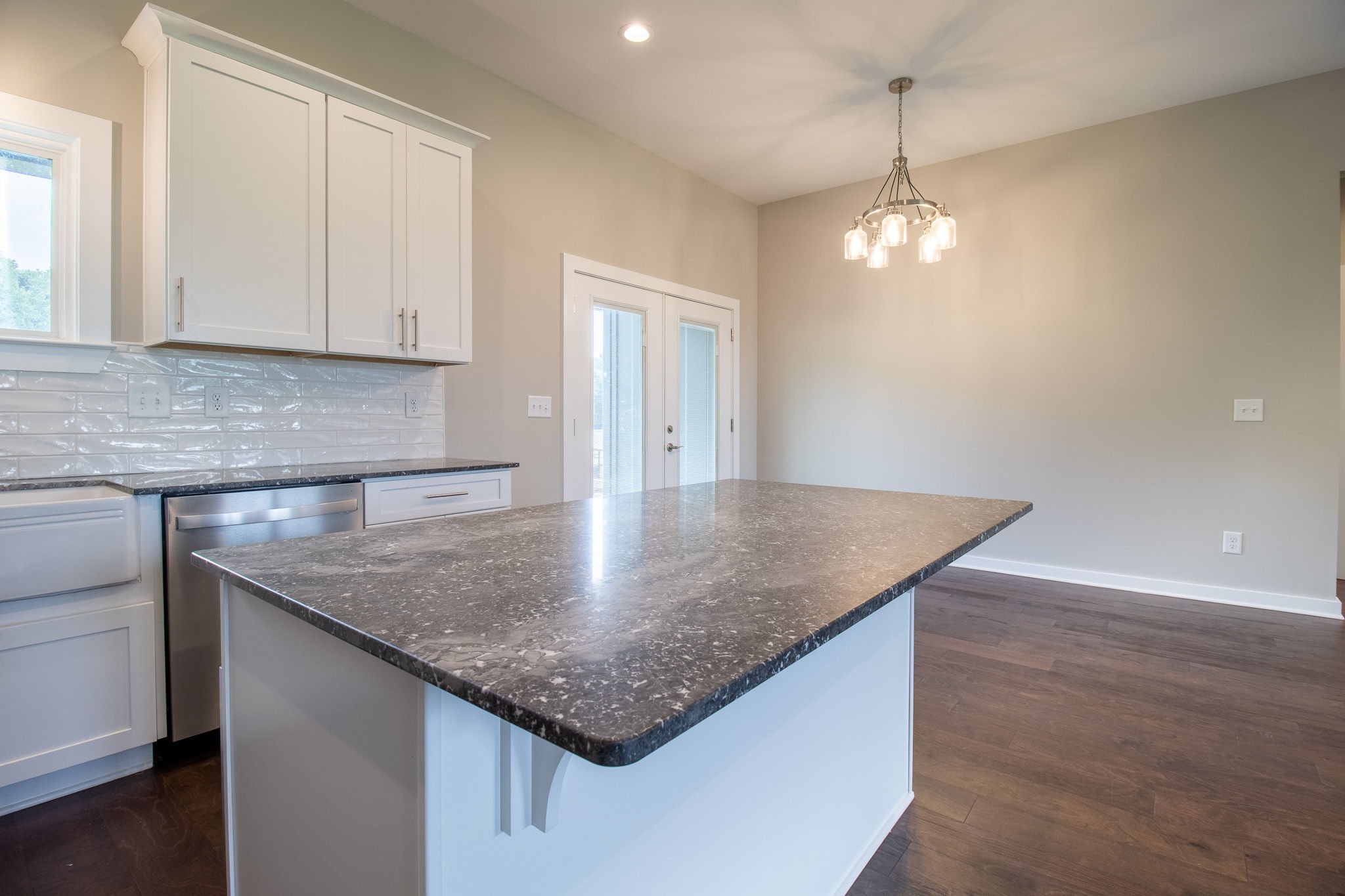 264 Dink Rut Road Portland, TN 37148 - Photo 23 of 56 a kitchen with stainless steel appliances granite countertop a sink dishwasher and white cabinets with wooden floor