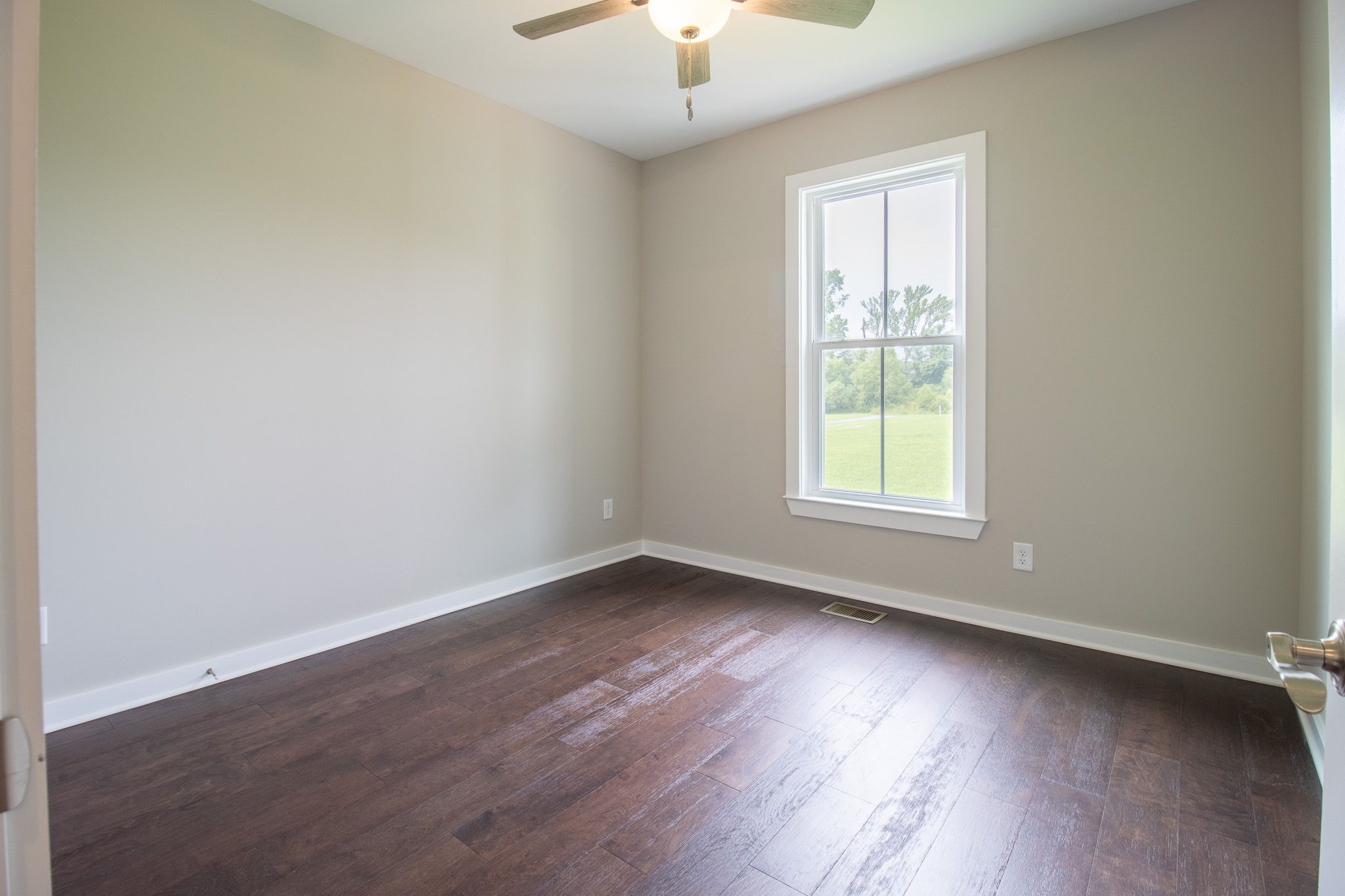 264 Dink Rut Road Portland, TN 37148 - Photo 35 of 56 an empty room with wooden floor and windows