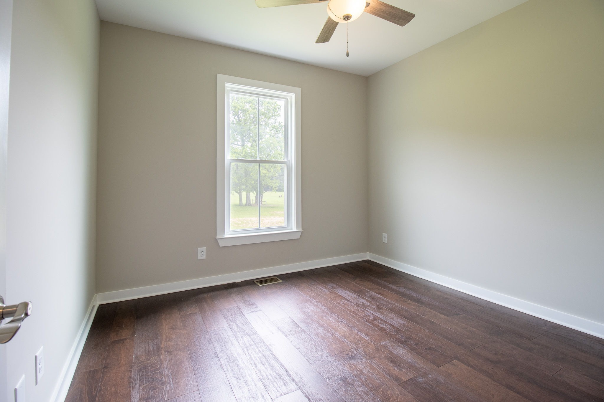 264 Dink Rut Road Portland, TN 37148 - Photo 40 of 56 an empty room with wooden floor and windows