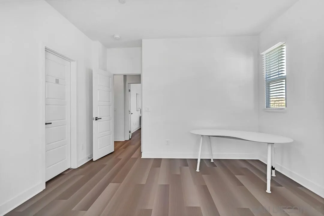 9041 West Bluff Place Santee, CA 92071 - Photo 22 of 42 a view of an empty room with wooden floor and a window