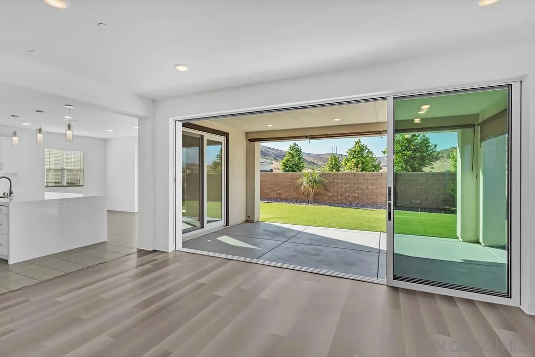 9041 West Bluff Place Santee, CA 92071 - Photo 9 of 42 a view of an empty room with wooden floor and a window
