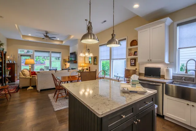 a kitchen with a table chairs stove and wooden floor