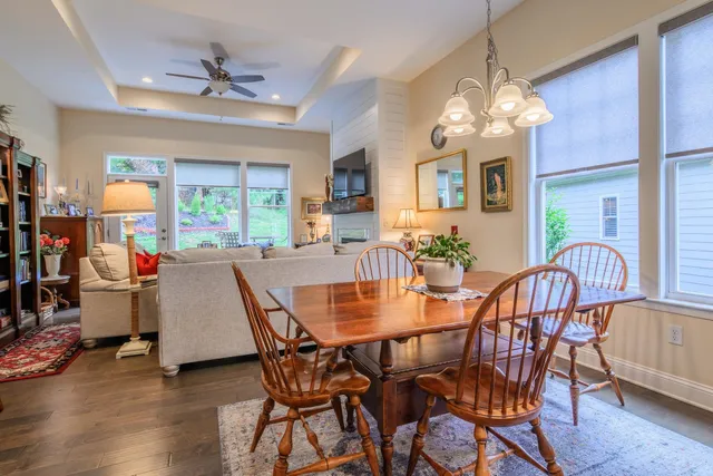 a view of a dining room with furniture a chandelier and wooden floor
