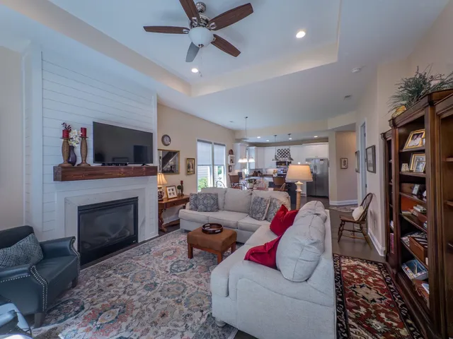 a living room with furniture a fireplace and a flat screen tv