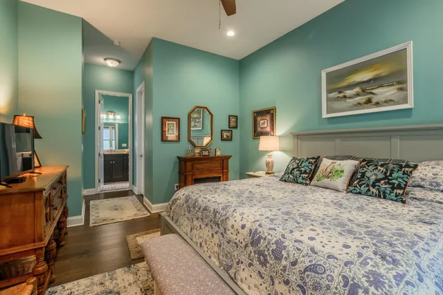 a bedroom with a large bed and a chandelier
