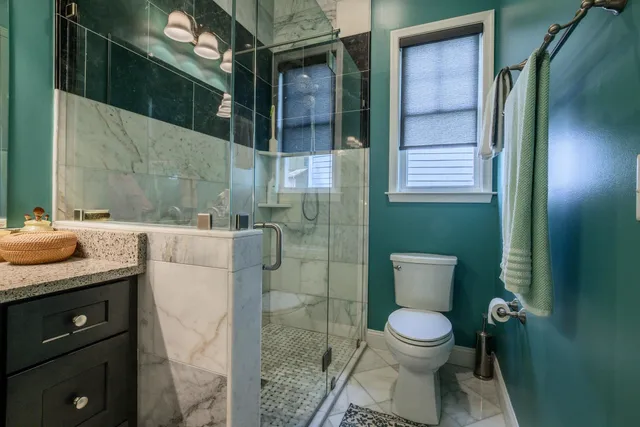 a bathroom with a toilet a sink and shower