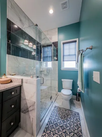 a bathroom with a sink a toilet and a mirror