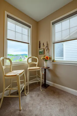 a view of a workspace with furniture and window