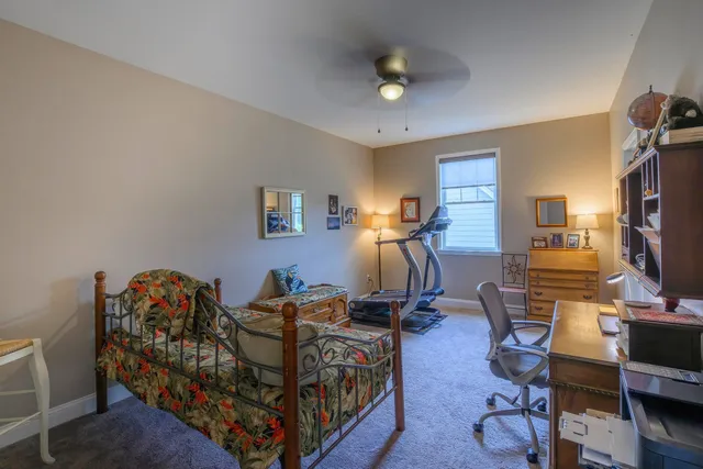 a bedroom with furniture a bed and a flat screen tv