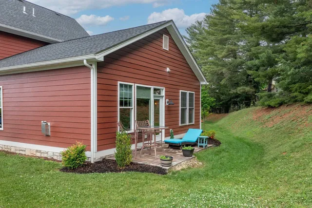a view of a house with backyard sitting area and garden