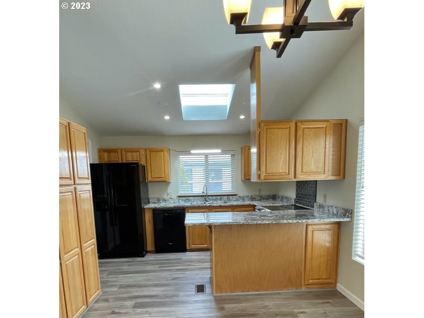 3355 North Delta Road Eugene, OR 97408 - Photo 3 of 15 a kitchen with granite countertop a refrigerator and a sink