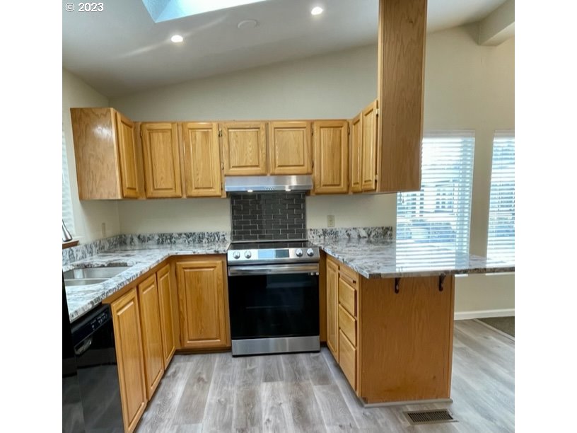3355 North Delta Road Eugene, OR 97408 - Photo 4 of 15 a kitchen with stainless steel appliances granite countertop a sink stove and refrigerator