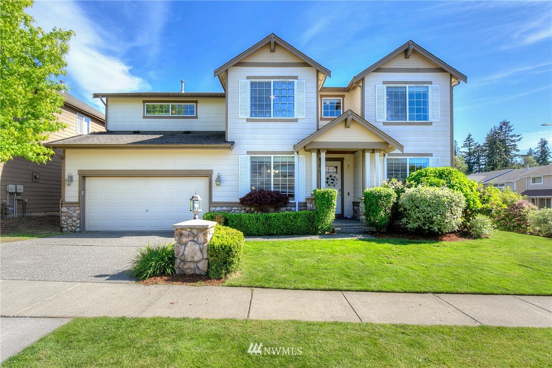 3922 216th Place Southeast Bothell, WA 98021 - Photo 1 of 33 a front view of a house with a yard and garage