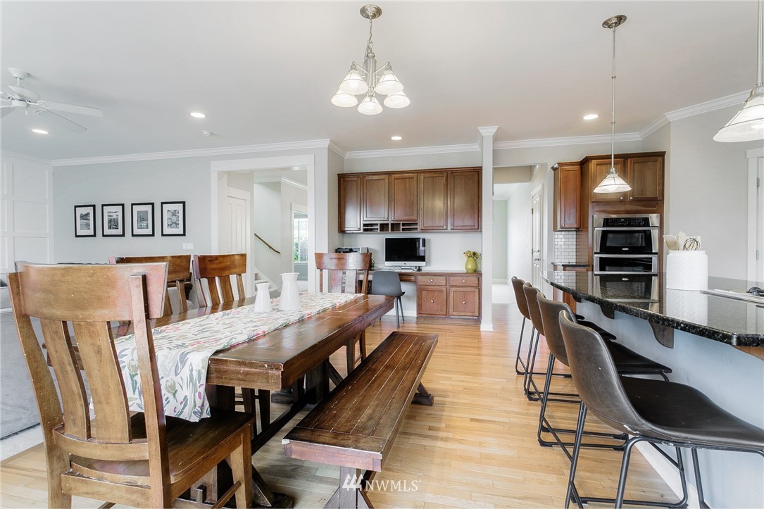 3922 216th Place Southeast Bothell, WA 98021 - Photo 3 of 33 a large kitchen with dining table chairs wooden floor and a chandelier
