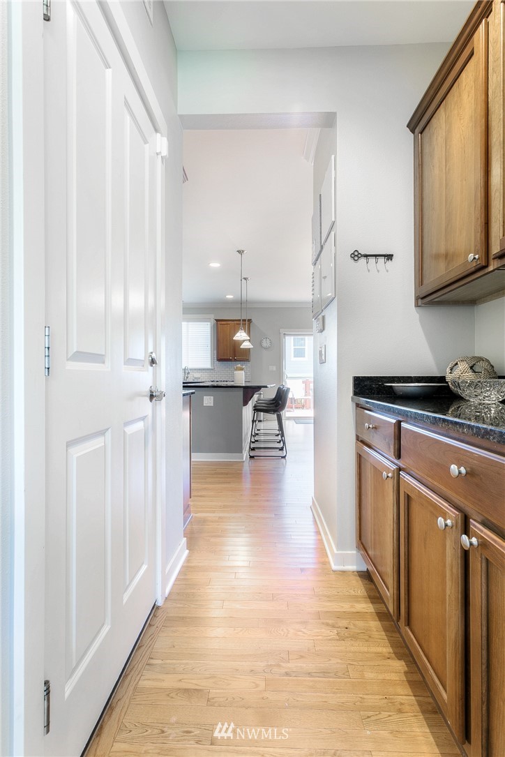 3922 216th Place Southeast Bothell, WA 98021 - Photo 7 of 33 a kitchen with stainless steel appliances granite countertop a refrigerator a stove and white cabinets with wooden floor