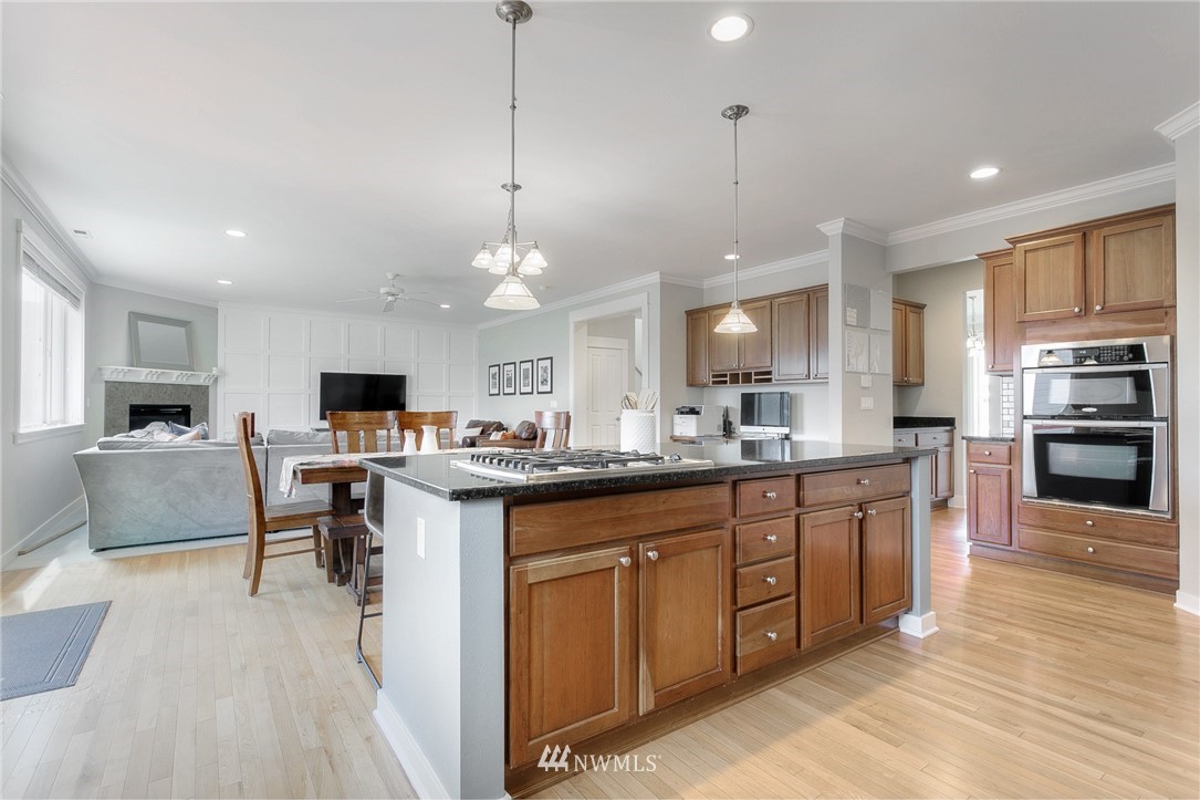 3922 216th Place Southeast Bothell, WA 98021 - Photo 9 of 33 a large kitchen with kitchen island a sink table and chairs