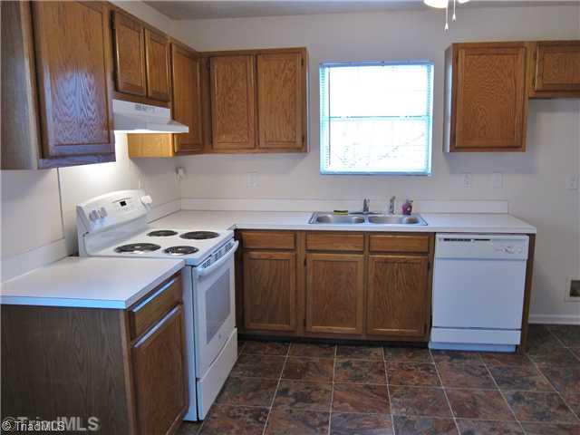 3733 Bason Road Mebane, NC 27302 - Photo 6 of 16 Kitchen. New range & hood, new vinyl floor.