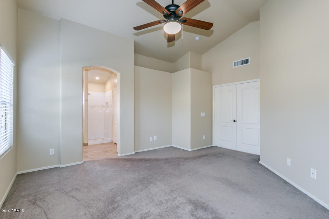 7292 South Roberts Road Tempe, AZ 85283 - Photo 18 of 38 an empty room with closet and a chandelier fan