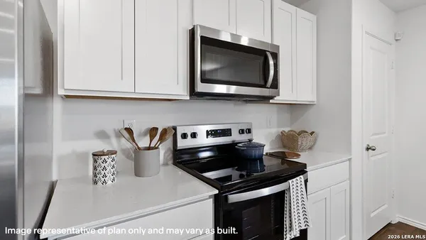 a kitchen with a stove and a microwave
