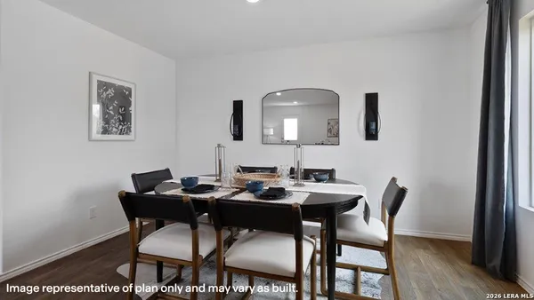 a dining room with furniture and wooden floor