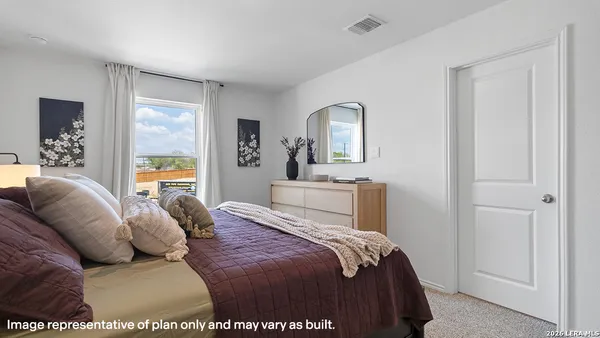 a bedroom with a large bed and a couch