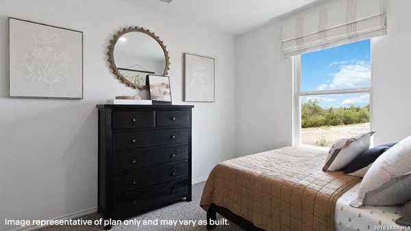 a bedroom with a bed and a mirror