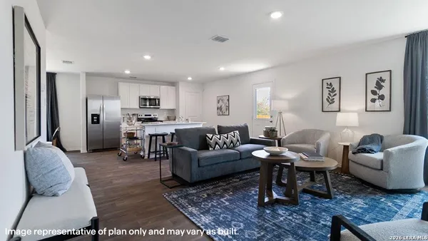 a living room with furniture and kitchen view